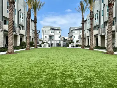 a large yard with palm trees in front of buildings at #Marbella Lane-Luxury Designer 3BR Home Disneyland in Anaheim