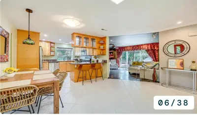 a kitchen and living room with a table and chairs at Emeric Estate in Simi Valley