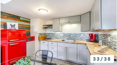 a kitchen with a red refrigerator and white cabinets at Emeric Estate in Simi Valley