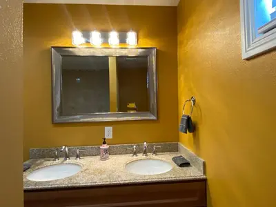 a bathroom with two sinks and a mirror at Faith House in Los Angeles