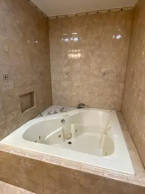 a large white bath tub in a bathroom at Faith House in Los Angeles