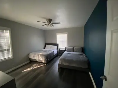 a bedroom with two beds and a ceiling fan at Faith House in Los Angeles
