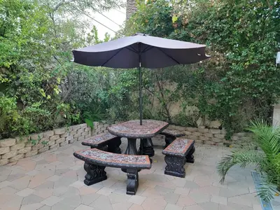 a picnic table and bench with an umbrella at 3 bedroom apartment by the MrC Hotel and 5 minutes to Rodeo Drive WiFi TV Patio walk to restaurants in Los Angeles