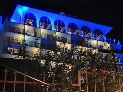 a building with people sitting on the balconies at night at 3 bedroom apartment by the MrC Hotel and 5 minutes to Rodeo Drive WiFi TV Patio walk to restaurants in Los Angeles