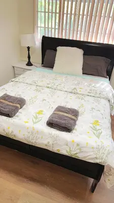 a bed with blankets and pillows on top of it at Pretty bedroom private bathroom in Hacienda Heights