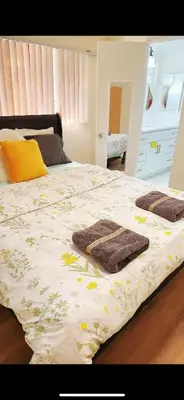 a bedroom with a bed with towels on it at Pretty bedroom private bathroom in Hacienda Heights