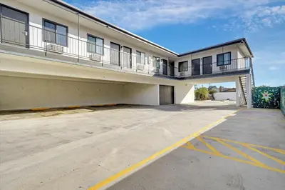 an empty parking lot in front of a building at Casablanca Inn in Bell