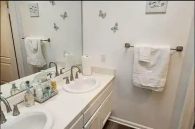a white bathroom with a sink and a mirror at Travelers Mini Stays - Revelation Nation Welcome in Simi Valley