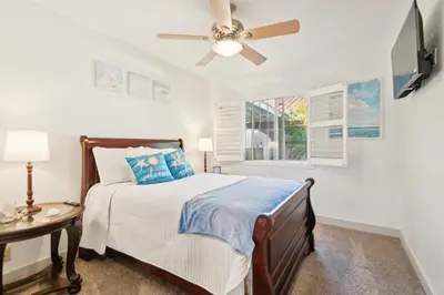 a bedroom with a bed and a ceiling fan at Peaceful Oasis in Anaheim