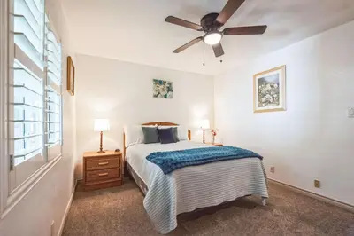 a bedroom with a bed and a ceiling fan at Peaceful Oasis in Anaheim