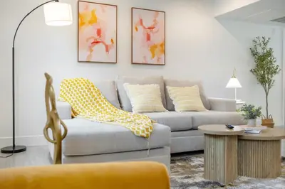 a living room with a couch and a table at Cozy Urban Retreat near Downtown LA & USC - Private room with shared Living room and kitchen in Los Angeles