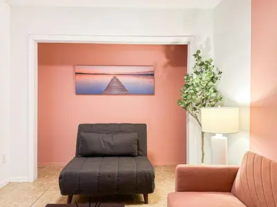a living room with a chair and a pyramid picture on the wall at Cozy 1-BR Poolside Getaway in West LA - LOU2 - WW in Los Angeles