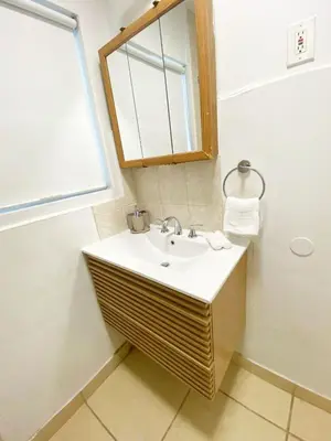 a bathroom with a sink and a mirror at Cozy 1-BR Poolside Getaway in West LA - LOU2 - WW in Los Angeles