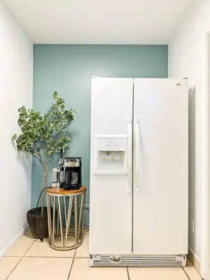 a white refrigerator in a room with a table at Cozy 1-BR Poolside Getaway in West LA - LOU2 - WW in Los Angeles