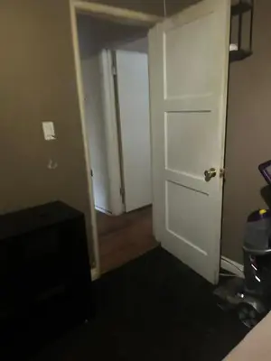 a room with a door and a room with a hallway at Cheryls home in Inglewood