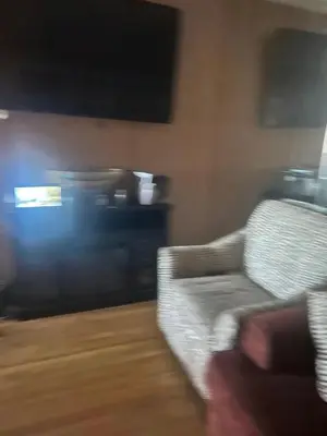 a living room with a couch and a television at Cheryls home in Inglewood