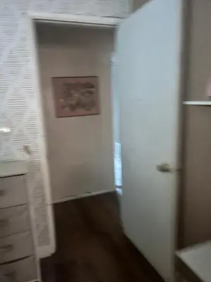 an empty room with a door and a painting on the wall at Cheryls home in Inglewood
