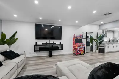 a living room with a couch and a flat screen tv at Spacious 4-bedroom Glendora Super House in Glendora