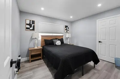 a bedroom with a bed and a white door at Spacious 4-bedroom Glendora Super House in Glendora