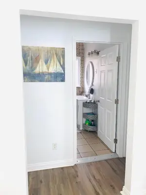 an open door into a bathroom with a mirror at Cozy Home Away From Home in Mojave
