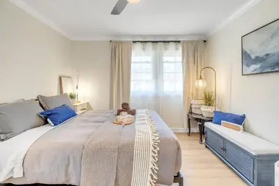 a bedroom with a large bed and a desk at Centrally Located Charming LA Home with Food Scenes in Monterey Park