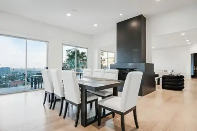 a dining room with a table and white chairs at Hollywood Hills Luxury Nest in Los Angeles