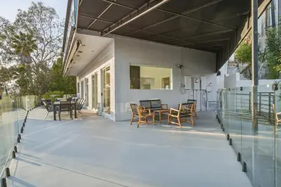 a patio with chairs and tables on a house at Hollywood Hills Luxury Nest in Los Angeles