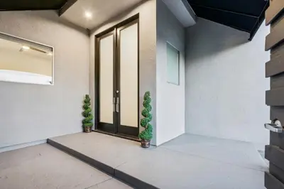 a front door of a house with two plants at Hollywood Hills Luxury Nest in Los Angeles