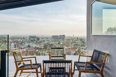three chairs on a balcony with a view of a city at Hollywood Hills Luxury Nest in Los Angeles