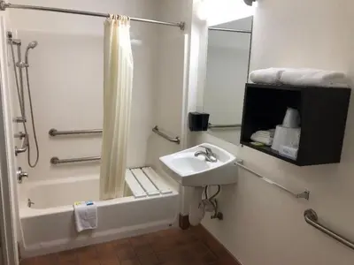 a bathroom with a sink and a shower and a bath tub at Inn Of Long Beach in Long Beach
