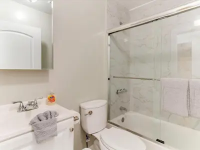 a bathroom with a shower and a toilet and a sink at Modern 3 Bedroom Apartment in San Fernando in San Fernando