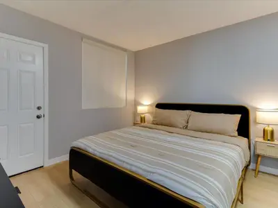a bedroom with a large bed with two lamps at Modern 3 Bedroom Apartment in San Fernando in San Fernando