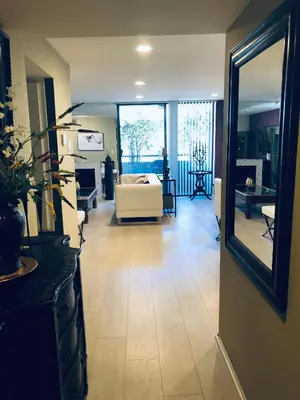a living room with a white couch and a mirror at Best Location West LA Spacious condo with hottub in Los Angeles