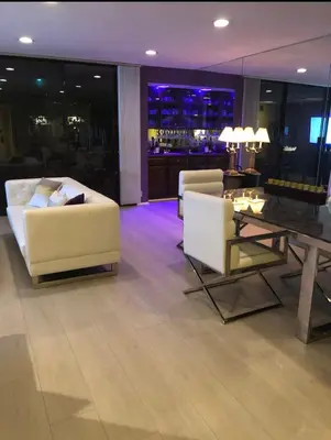 a living room with two white chairs and a table at Best Location West LA Spacious condo with hottub in Los Angeles