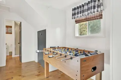 a large wooden foosball table in a room at Village Relaxation at Camp Conklin Big Bear - Hot Tub in Big Bear Lake