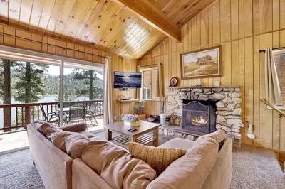 a living room with a couch and a fireplace at Inspiration Point Retreat by Big Bear Vacations in Big Bear Lake