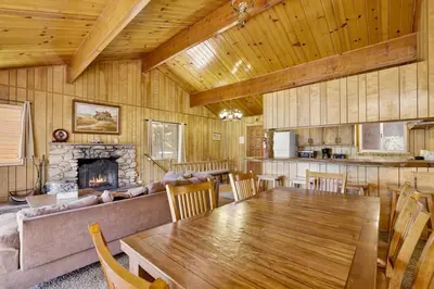 a living room with a table and a couch at Inspiration Point Retreat by Big Bear Vacations in Big Bear Lake