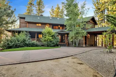 a home with a gambrel roof and a driveway at Eagle Point Lake House by Big Bear Vacations in Big Bear Lake