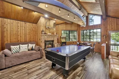 a living room with a pool table in it at Serenity Cove Lake House by Big Bear Vacations in Big Bear Lake