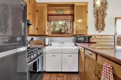 a kitchen with a white sink and a stove at The Nest on Towne Trail by Big Bear Vacations in Big Bear Lake
