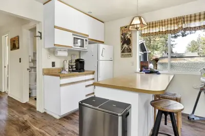 a kitchen with white cabinets and a counter top at Green Squirrel Chateau by Big Bear Vacations in Big Bear Lake