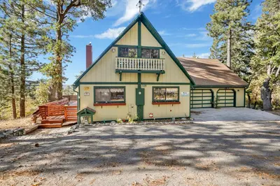 a house with a balcony on top of it at Mountain Hideaway on Maryland by Big Bear Vacations in Big Bear Lake