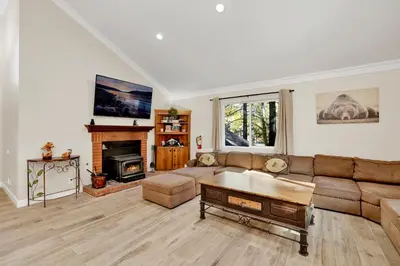 a living room with a couch and a fireplace at Temple Bear Chalet by Big Bear Vacations in Big Bear Lake