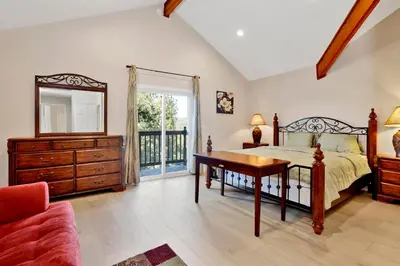 a bedroom with a bed and a dresser and a mirror at Temple Bear Chalet by Big Bear Vacations in Big Bear Lake