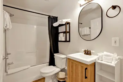 a bathroom with a sink and a toilet and a mirror at Temple Bear Chalet by Big Bear Vacations in Big Bear Lake