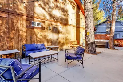 a patio with chairs and a table and a couch at Temple Bear Chalet by Big Bear Vacations in Big Bear Lake