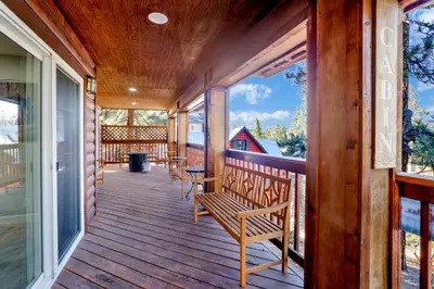 a porch of a house with benches on it at Temple Bear Chalet by Big Bear Vacations in Big Bear Lake