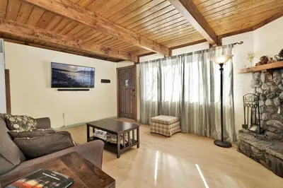 a living room with a couch and a table at Aeroplane Gambrel Chalet- Adorable Airport Retreat Cottage in Big Bear City