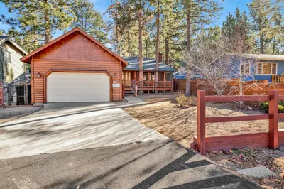 a house with a garage and a fence at Oriole House- Walk to Lake Chalet w/ Hot Tub in Big Bear Lake