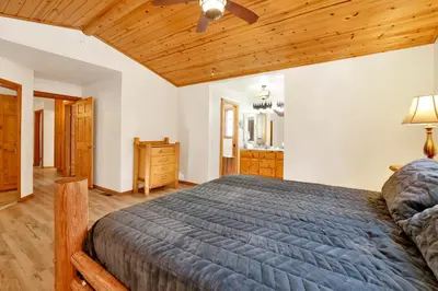 a bedroom with a bed and a wooden ceiling at Oriole House- Walk to Lake Chalet w/ Hot Tub in Big Bear Lake
